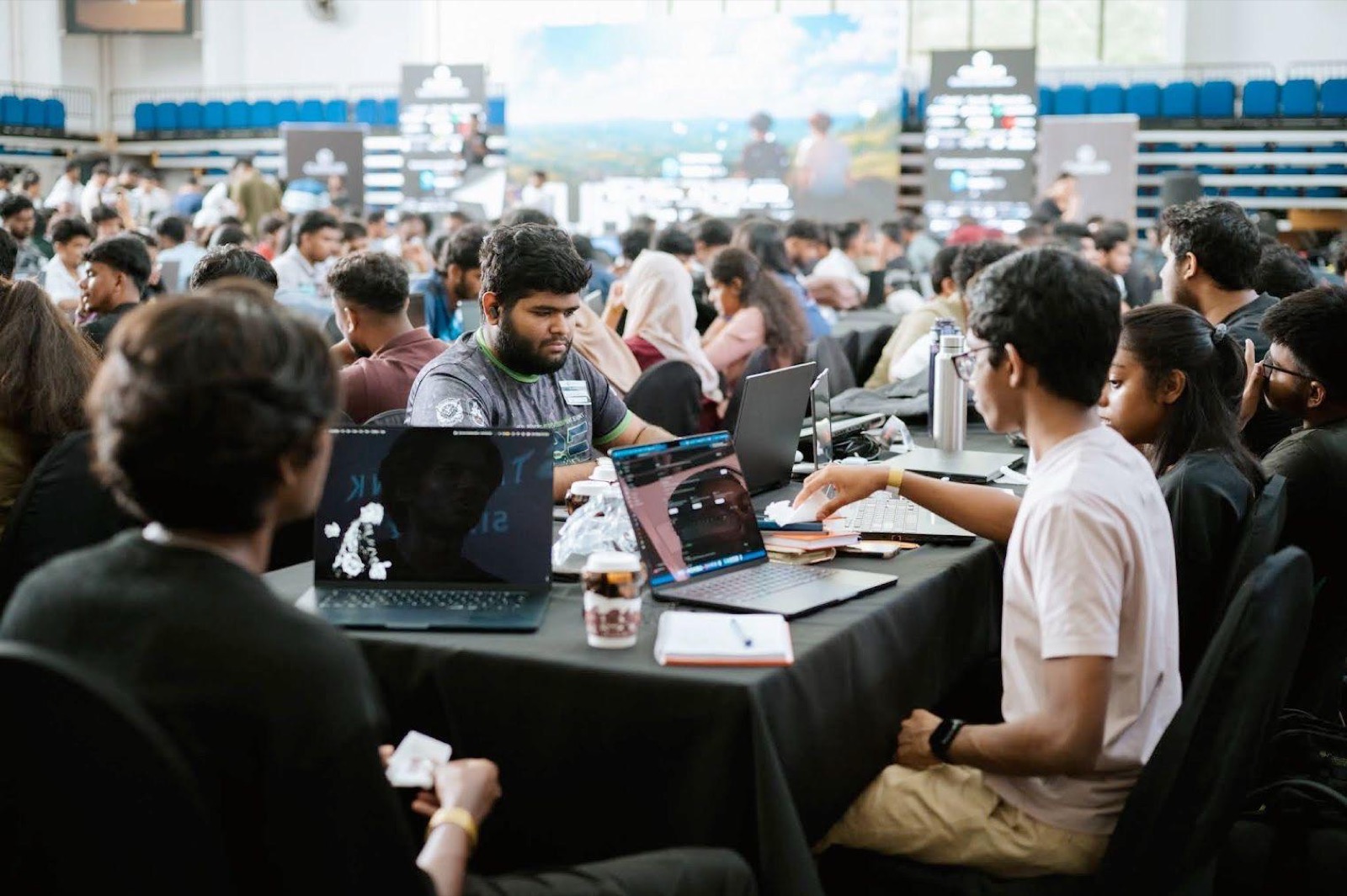 BitByBit teammates heads-down at laptops with a notebook open on the table